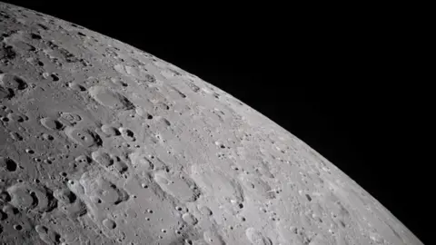 A cratered section of the moon is seen close-up
