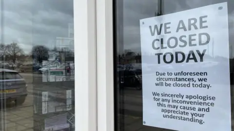 Qays Najm/BBC A sign on a cafe door reads: "We are closed today. Due to unforeseen circumstances, we will be closed today. We sincerely apologise for any inconvenience this may cause and appreciate your understanding." 