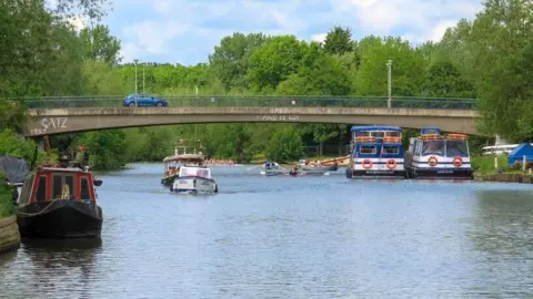 Steve Daniels A car crosses the bridge while boats sail underneath it.