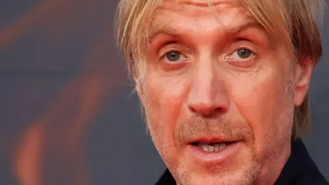 British actor Rhys Ifans poses on the red carpet upon arrival to attend the HBO original drama series "House of the Dragon" premiere at Leicester Square Gardens, in London, on August 15, 2022