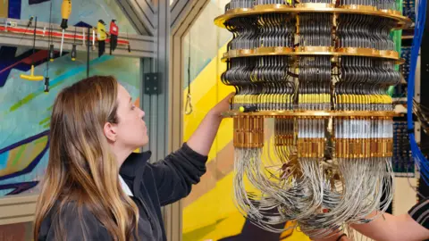 Google an engineer works on a quantum computer part.