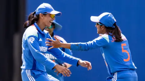Jemimah Rodrigues of India (right) celebrates with team mates after taking a catch to dismiss Nat Sciver-Brunt of England during the 1st Women's ODI between England and India at Utilita Bowl 