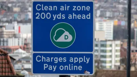 A sign warns motorists of the start of the clean air zone