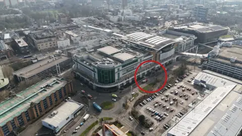 An aerial view of West Quay shopping centre shows an industrial part of Southampton, with a red circle highlighting the area of the incident