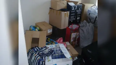 Hull City Council Boxes and bags filed with products piled in a room.