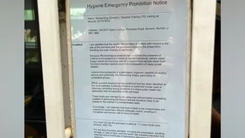 A Hygiene Emergency Prohibition Notice has been placed on a window inside the restaurant, detailing why it has been closed and by whom.