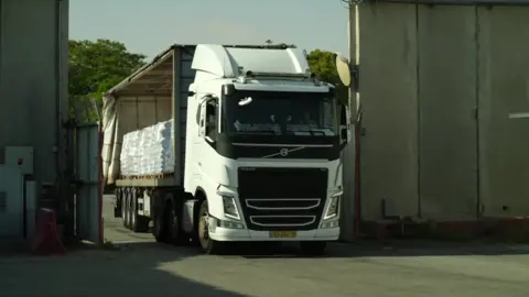 A lorry carrying humanitarian aid for Gaza enters an inspection area at the Israeli-controlled Kerem Shalom crossing with Gaza