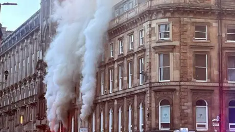 Plumes of smoke rising from a building