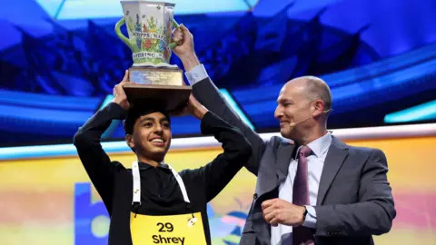 Shrey Parikh lifts the trophy after winning the annual Scripps National Spelling Bee.