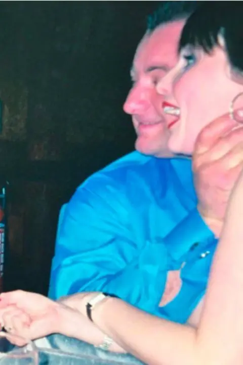 Rachel Williams An old photograph showing a man in a blue shirt with his hand around a woman's throat. She is looking away from the camera but has a surprised expression on her face.