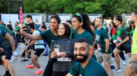 Runners taking a selfie at the start of the marathon