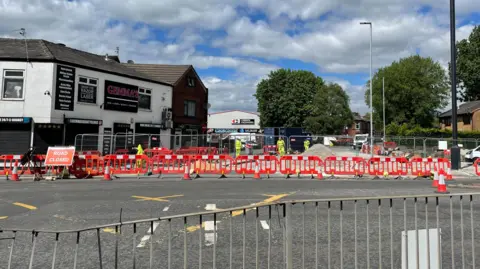 LDRS Barriers are in place at the junction to a road, with a sign saying 'road closed'.
