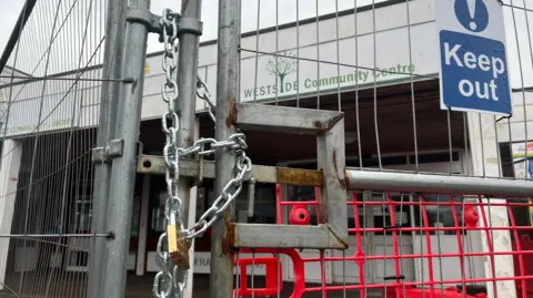 BBC Chains and a padlocks on steel gates outside 