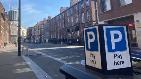 A 'pay here' sign in a street in Liverpool city centre.