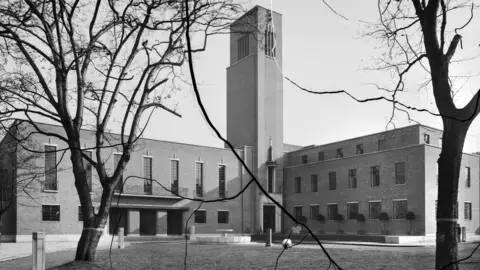 Historic England Archive A black and white image of the exterior of the building when it was opened.