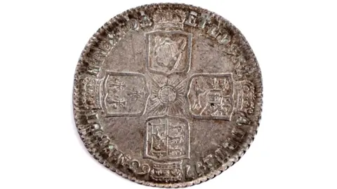 Anderson & Garland A round coin which is browning in colour and bears the image of four different crests.