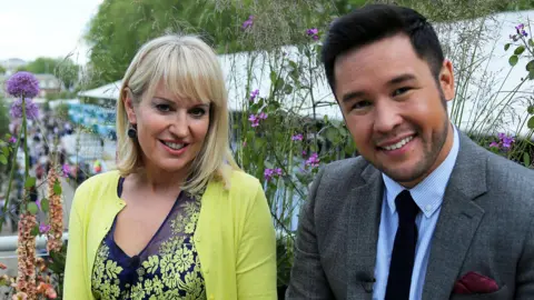 Nicki Chapman is sitting next to TV presenter and garden designer James Wong at the Chelsea Flower Show in 2022.