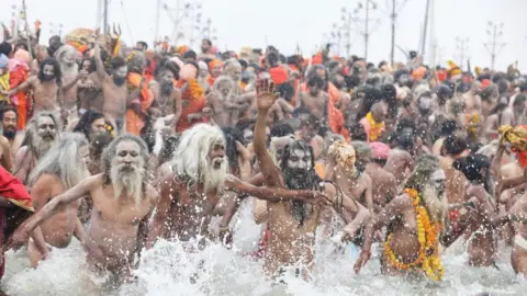 Ankit Srinivas Holy men seeing rushing into the river for a dip