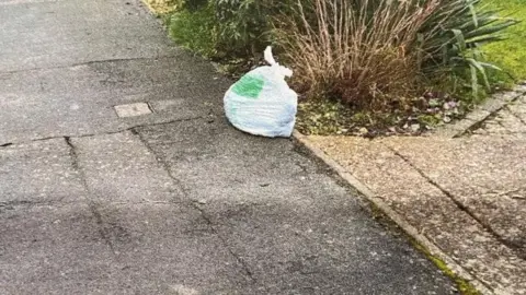 Supplied A charity shop collection bag is left out on the street