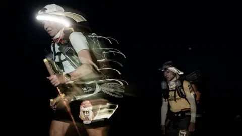 Lesley Malloch Lesley Malloch running in the pitch black of night in the Sahara.
