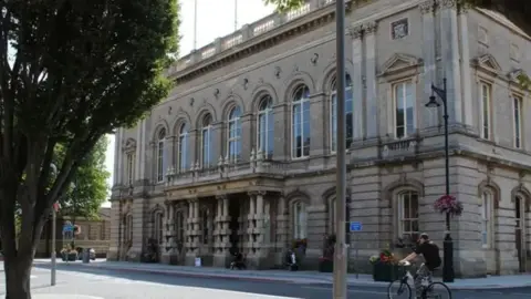 NE Lincolnshire Council A cyclist rides past the two-storey North East Lincolnshire Council town hall in Grimsby 
