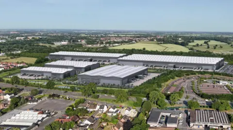 A CGI image of five grey warehouse superimposed on a countryside image