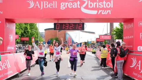 THE AJ BELL GREAT BRISTOL RUN Runners crossing a finishing line 