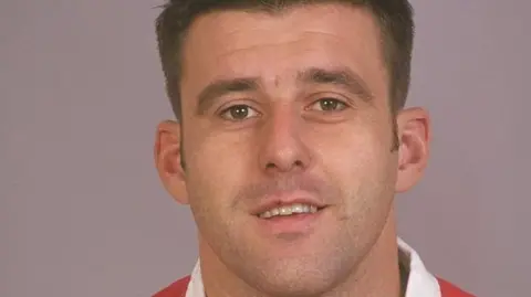 David Rogers/Getty Images Matthew Back wearing Welsh rugby kit and looking directly at camera with neutral background