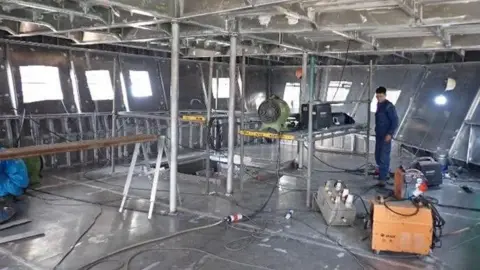 Isles of Scilly Steamship Group Unpainted steel wheelhouse of new vessel surrounded by scaffolding.