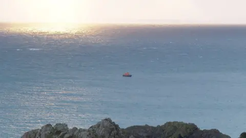 BBC A picture of the view from St Martin's point. The sea can be seen with part of the island towards the bottom of the picture. The lifeboat is on the water