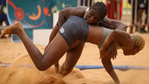 Cem Ozdel/Getty Images Two women compete in Senegal's beach competition