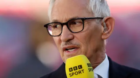 Getty Images Gary Lineker speaking into a yellow BBC Sport microphone and looking off camera