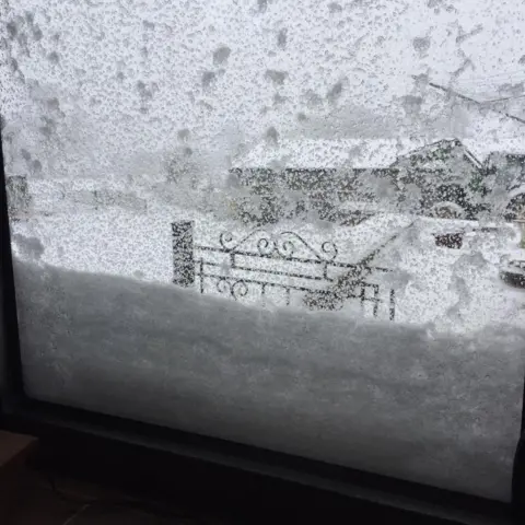 Ffion Williams Snow climbing up the window in Llannefydd, Conwy county