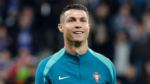 Cristiano Ronaldo smiles while on duty with Portugal
