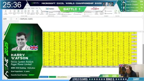 Financial Modelling World Cup Screengrab of Harry's Excel sheet. To the left there is a box with information about the IT professional and to the bottom right there is a shot of him with his headset on, completing his task live