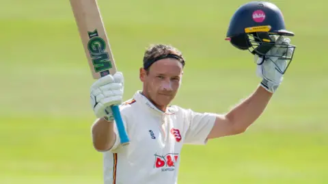 Tom Westley raises his bat after his century for Essex against Yorkshire