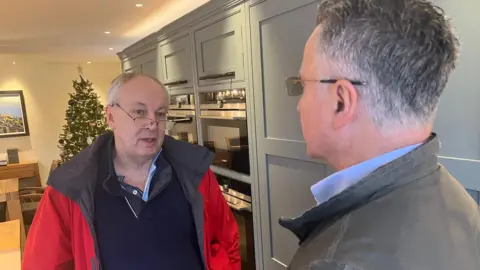 David Drew in his kitchen in conersation with CIL campaigner Steve Dally