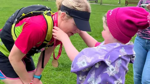 Kyle Langenegger Lou McCallion receiving her medal from Jessie 