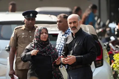 Reuters An Iranian Embassy official (R) reacts while standing in front of Galle National Hospital, where injured sailors are receiving treatment, following a submarine attack on the Iranian military ship, IRIS Dena, off the coast of Sri Lanka, in Galle, Sri Lanka, March 5, 2026. REUTERS/Thilina Kaluthotage