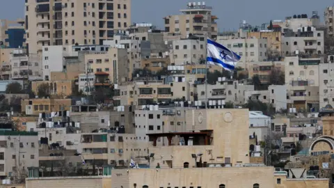 An Israeli flag flies from an Israeli settlement in Hebron, in the occupied West Bank (9 February 2026)