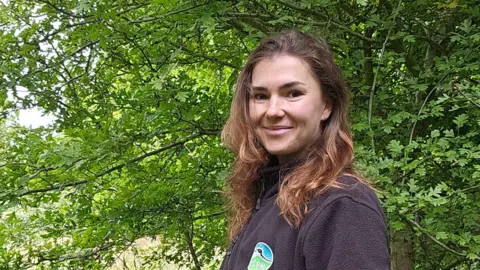 Sophie Arnold/RSPCA Sophie Arnold turned to look at the camera with a young and very leafy tree behind her