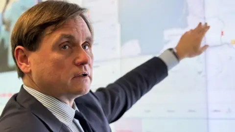 Vilmantas Vitkauskas runs Lithuania's crisis management centre and speaks to the BBC in front of a giant digital wall map that charts all the balloons spotted so far this year.