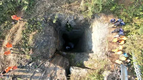 Defense PRO, Guwahati The photo shows a pit, dug dozens of feet into the ground, into which miners descend to extract coal