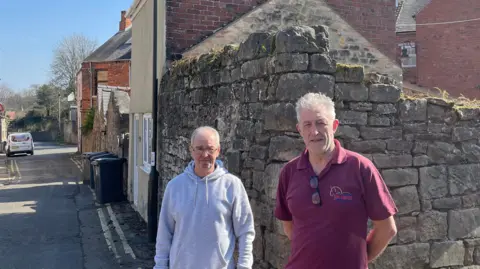 Steve Gray and David Ellis outside the building where the suitcase was found in Whitwell in North East Derbyshire