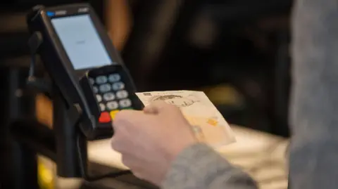 Getty Images Cash and card machine payment options