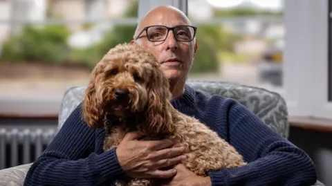 Richard Freedman with Chester the cockapoo