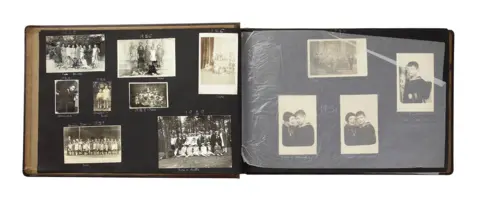 Sara Davidmann Open pages of Susi’s photo album with black and white photographs on a black background