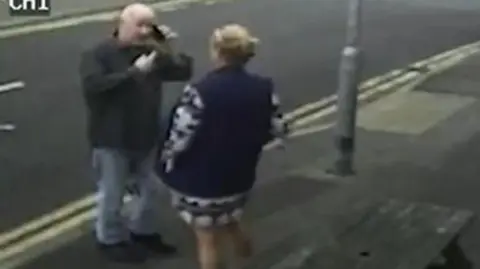 CPS Stephanie Langley and Matthew Bryant on a pavement facing each other, he is on the phone