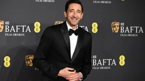 Getty Images Adrien Brody in a black tuxedo and bow tie
