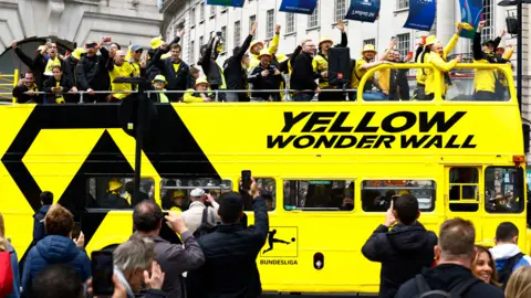 Reuters Borussia Dortmund fans are seen on a double decker bus at Piccadilly Circus before the match